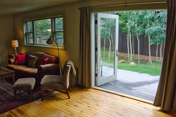 Living area with french doors to deck and backyard with grill and firepit