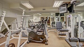 A gym with various exercise equipment, including treadmills, weight machines, and a rowing machine. - Free SkyCard Act-Fitness Center, Gas Fireplace - Highland Greens Lodge 305 (Breckenridge)