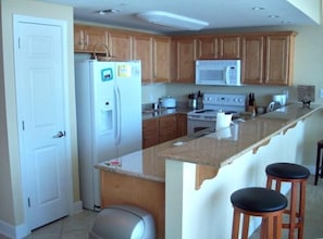 Kitchen with granite countertops and fully stocked.