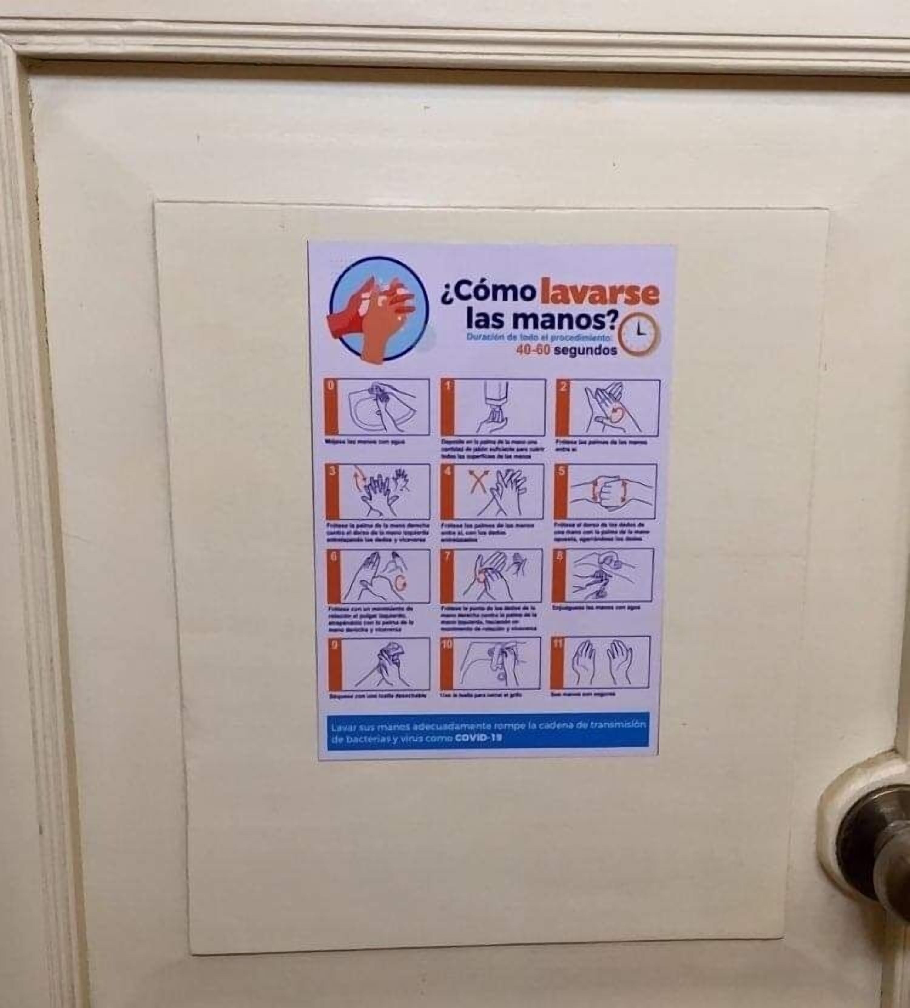 A poster with handwashing instructions on a door.