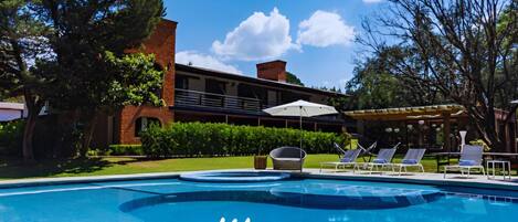 Outdoor pool, open 9:00 AM to 9:00 PM, pool umbrellas, pool loungers