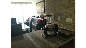 Cozy living space with a kitchenette, dining table, and comfortable sofa.