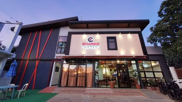 A modern building with a sign reading "CHARMS HOTEL". - Charms Hotel (Coron)