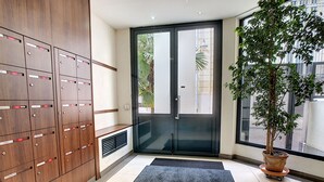 A modern interior with a large wooden cabinet, a sliding glass door, and a potted plant.