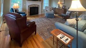 A living room with a fireplace, a sofa, a chair, a coffee table, and a lamp. - An Inspirational View.... (Horse Shoe)