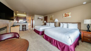 A hotel room with two beds, a desk, a chair, a TV, and a kitchenette. - GrandView 200 - Luxury Waterfront condo (Chelan)