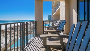 A balcony with a view of the beach and a pool. - 3rd Floor ~ 2 Bedroom @ Phoenix 10 ~ (Orange Beach)
