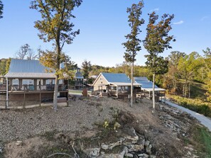 A resort with multiple cabins, each featuring a balcony and a solar panel roof.