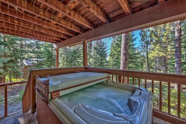 A hot tub with a wooden deck and a view of a forest. - Where Eagles Fly, Hot Tub, Pets ok, great spot (South Lake Tahoe)
