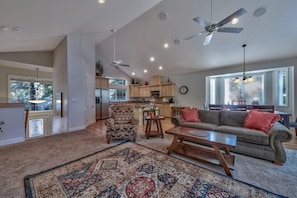 A spacious living area with a sofa, coffee table, and patterned rug.