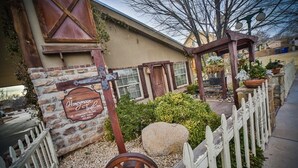 A rustic building with a stone wall, wooden door, and a sign that reads "Honeymoor Trail Cafe." - Stay in the Zion themed inn!3348714 a new 2nd rental. The Silo Inn (Washington)
