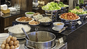 A buffet with various food items including eggs, noodles, and vegetables. - Minh Chien Hotel (Xuan Huong - Da Lat)