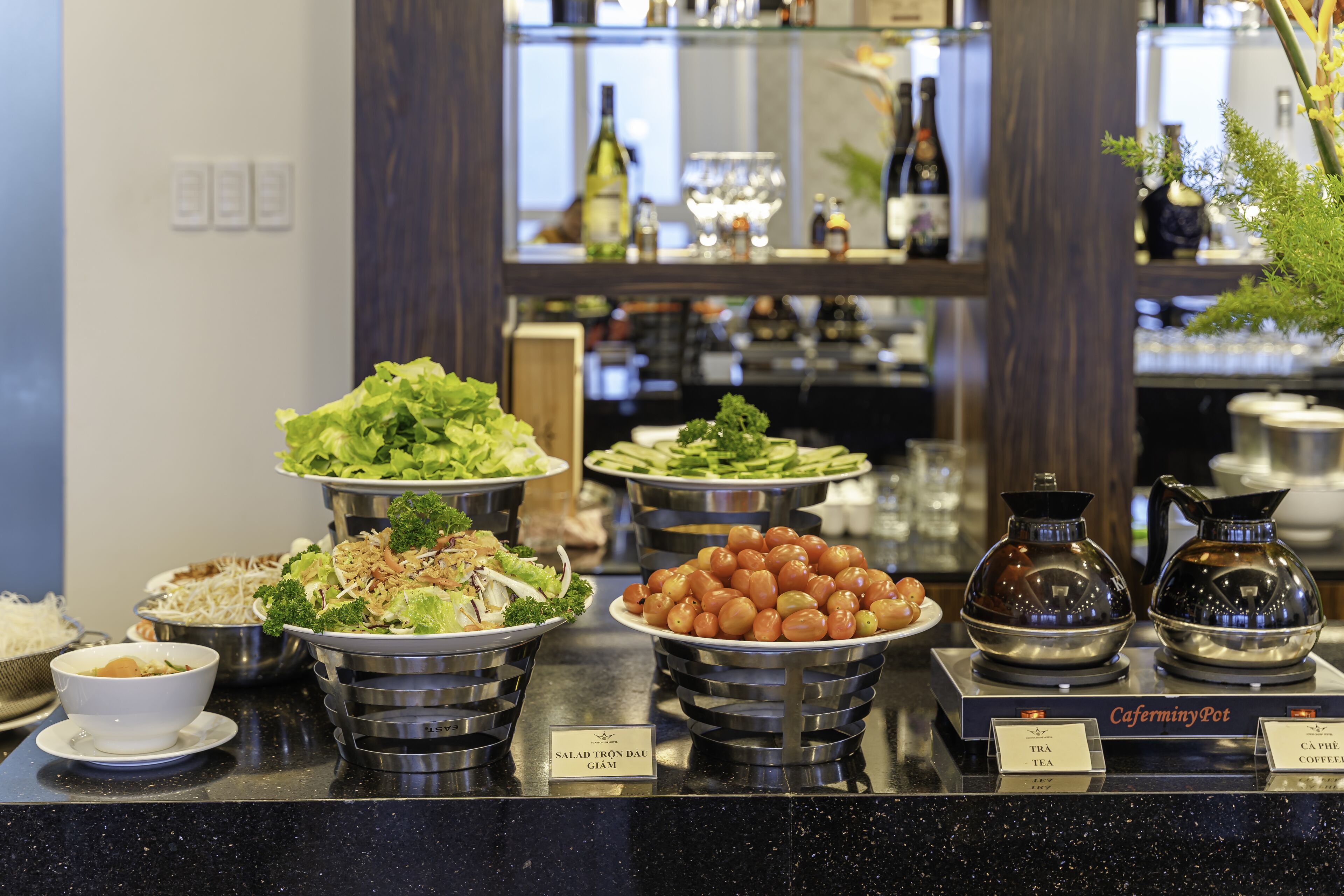 A buffet with various dishes and a coffee station.