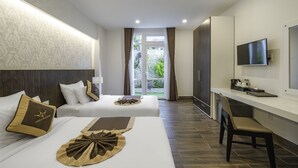 A hotel room with two beds, a desk, a chair, a TV, and a view of the outdoors. - Minh Chien Hotel (Xuan Huong - Da Lat)