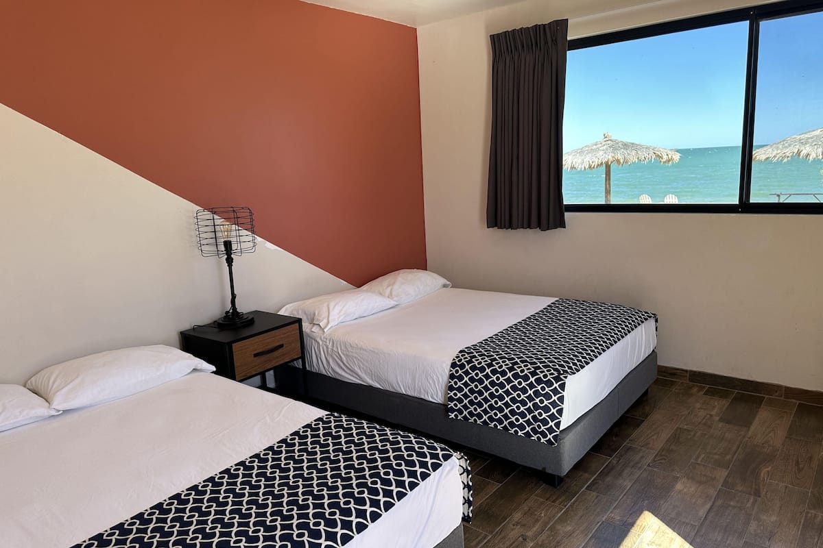 standard double room, 2 double beds, non smoking, beach view | 1 bedroom, desk, iron/ironing board, bed sheets