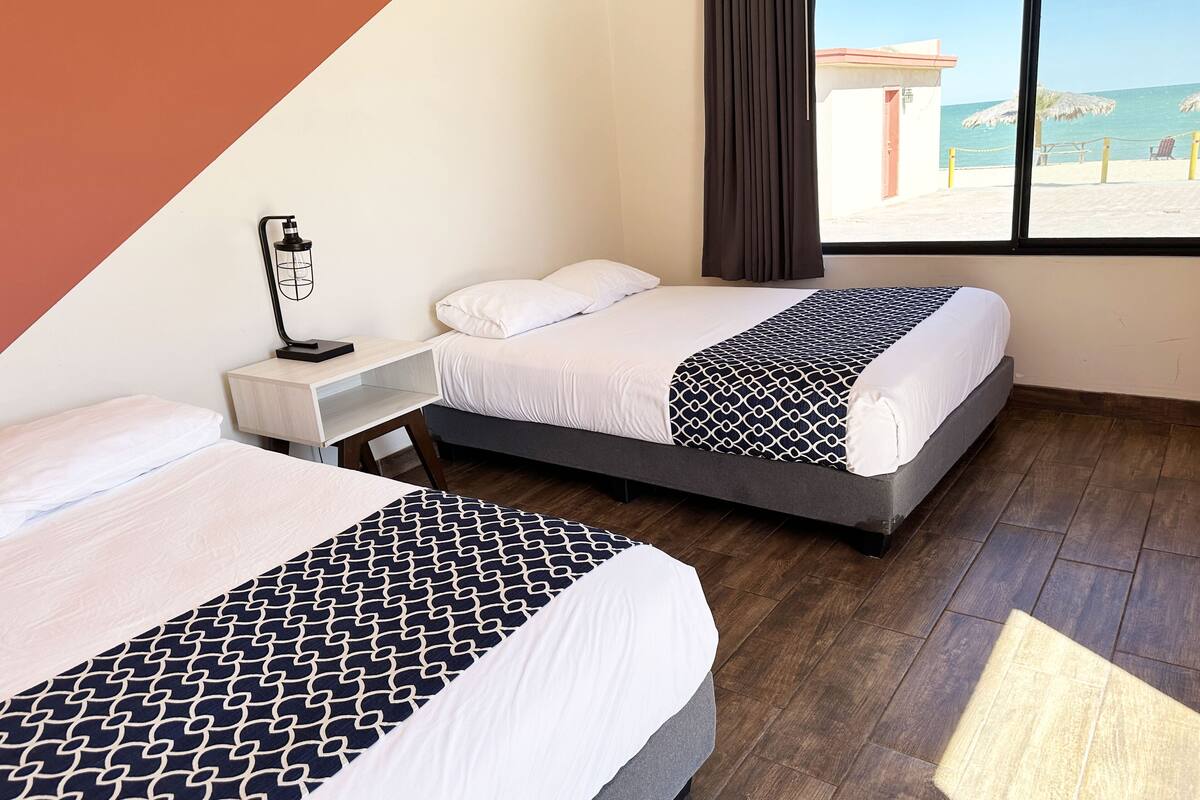 standard double room, 2 double beds, non smoking, sea view | 1 bedroom, desk, iron/ironing board, bed sheets