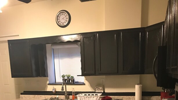 A kitchen with dark cabinets, a granite countertop, a sink, and a clock on the wall. - Royal Retreat 3 Downtown South Charleston  (South Charleston)
