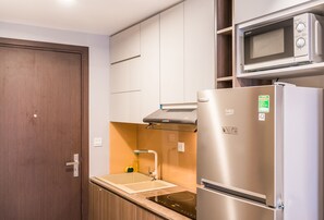 Fridge, microwave, cookware/dishes/utensils, dining tables