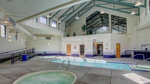 An indoor swimming pool with a hot tub, a staircase, and a mezzanine level with windows. - Lively condo-central location! Ready your great adventures for every season! (Silverthorne)