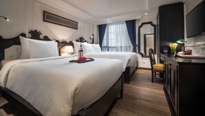 A hotel room with two beds, a desk with a chair, a television, and a large window with curtains. - My Boutique Hotel & Spa (Sa Pa)