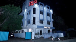 A multi-story building with a sign reading "Balaji AC Lodges." - Balaji Lodging (Pandharpur)