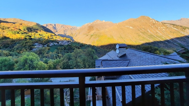 A mountain landscape with a house and a balcony.
