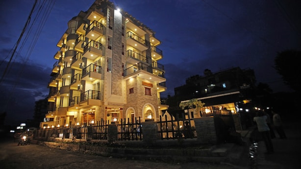 A multi-story hotel with balconies and a stone facade. - Durbar Suite (Pokhara)