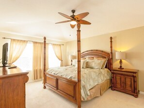 A four-poster bed with a wooden headboard, a standing lamp, and a ceiling fan. - Fv43009 - Windsor Hills Resort - 6 Bed 4 Baths Villa (Kissimmee)