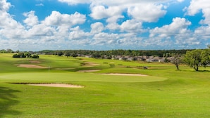A golf course with bunkers, a flagstick, and a clear blue sky. - Ip60138 - Highlands Reserve - 5 Bed 3 Baths Villa (Davenport)