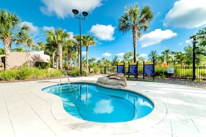 A swimming pool with a rock centerpiece, surrounded by palm trees and a paved deck. - Aco253282 - Solterra Resort - 4 Bed 3 Baths Townhome (Davenport)