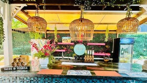A bar area with a mosaic tile countertop, hanging wicker lamps, and a sign indicating 'TACOS & TEQUILA'. - Hidden Gem Barbados (Inch Marlowe)