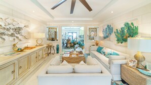 A spacious living room with a ceiling fan, a coffee table, and a sofa. - Hidden Gem Barbados (Inch Marlowe)