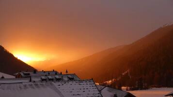 A mountainous landscape with a sunset.