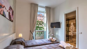 A hotel room with two beds, a TV, a balcony with curtains, and a view of buildings. - Rome Central Rooms Guest House (Rome)