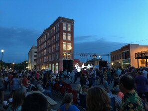 A crowded outdoor event with a stage and audience. - Frontier Hotel Pawhuska (Pawhuska)