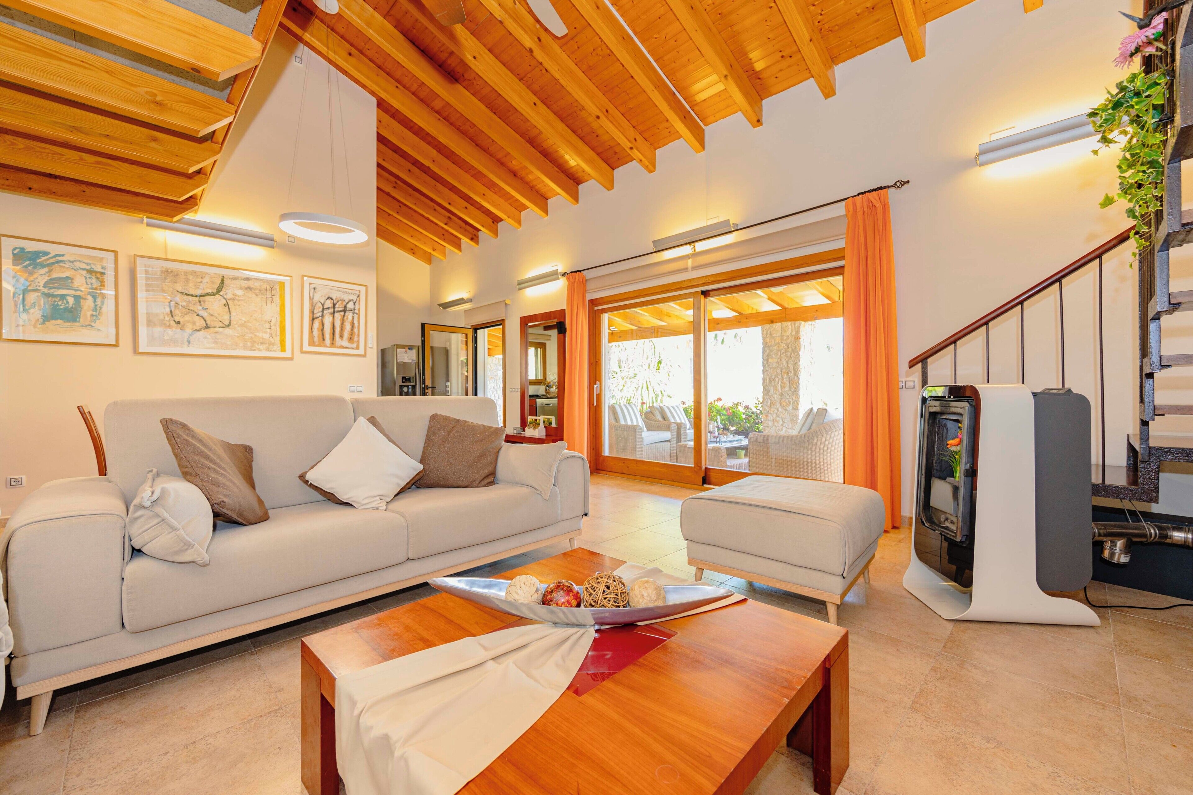 A modern living room with a wooden ceiling, a sofa, a coffee table, and a fireplace.