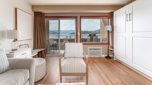 A modern hotel room with a large sliding glass door leading to a balcony with a scenic view. - Grandview 511 - Waterfront (Chelan)