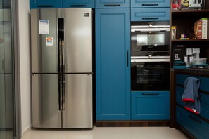 Departamento Deluxe, 3 habitaciones | Cocina privada | Refrigerador con congelador, microondas, horno y parrilla de estufa 