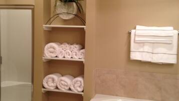 Bathtub, jetted tub, hair dryer, towels