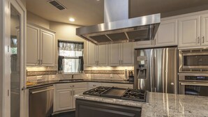 A modern kitchen with stainless steel appliances, a gas stove, and white cabinetry. - Huge Home in Downtown ATX/Large Groups Welcome/Walk Everywhere!!! (Austin)