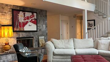 Smart TV, fireplace, books, printers