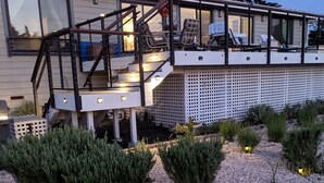 A modern house with a glass balcony, a staircase, and a garden with gravel and plants. - New Home w Expansive Ocean and Sunset Views, Steps to the Seal Cove Beach (Moss Beach)