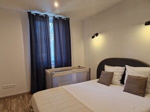 1 bedroom, desk, iron/ironing board, travel crib