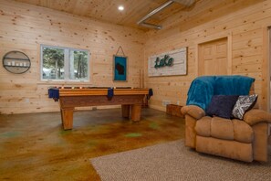 "The cabin was clean and had plenty of supplies and linens.  It had a pool table, video games, comfortable furniture and an extra refrigerator."