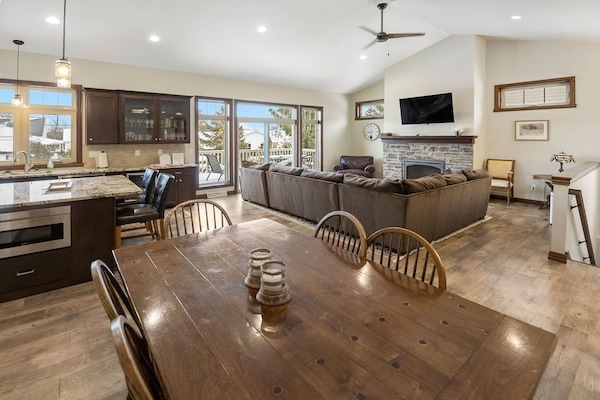 Dining area into living room, stairs down to lower level.