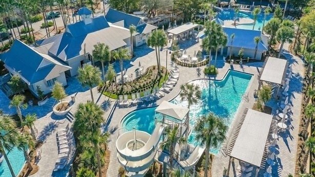 A resort with multiple swimming pools, palm trees, and modern architecture. - 5 BDRM & 6 seat golf cart! On the green, everything for KIDS, 2 King BDRMs (Santa Rosa Beach)