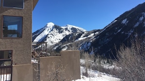 A building with a mountain view, a balcony, and a snow-covered landscape. - Open, Airy Mountaintop Home (Carbondale)