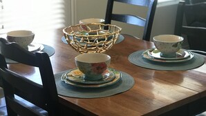A dining table with a bowl, a cup, and a chair. - Green River Mesa…your home away from home! (Green River)