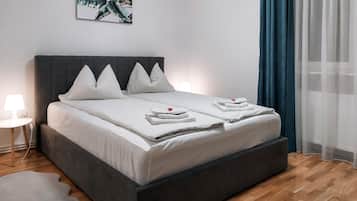 Restful retreat with a large bed, bedside table, and decorative wall art.