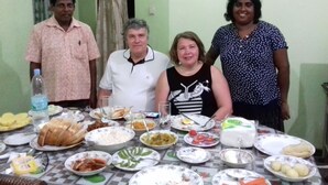A dining table with various dishes and a bottle of water. - Prasad Suomi Villa (Matara)